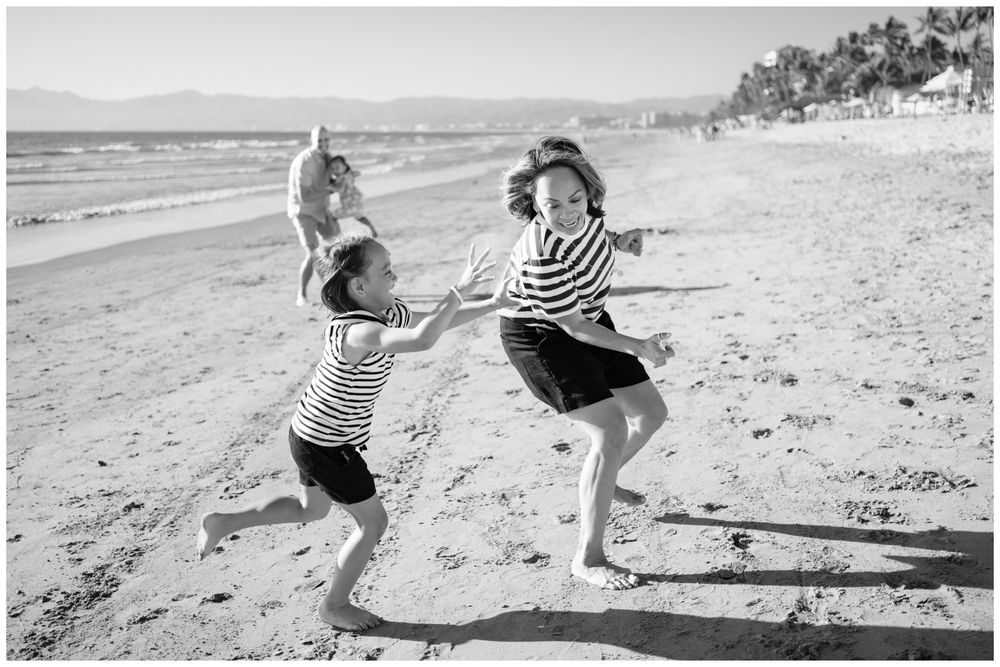 Black and white portrait of a child playing on the beach in Sayulita.