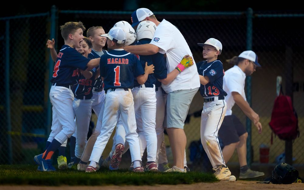 Hershey 11U Blue players and coaches mob each other in celebration after winning the District 6 Championship, by Deanna Fox, SportsFox Photo