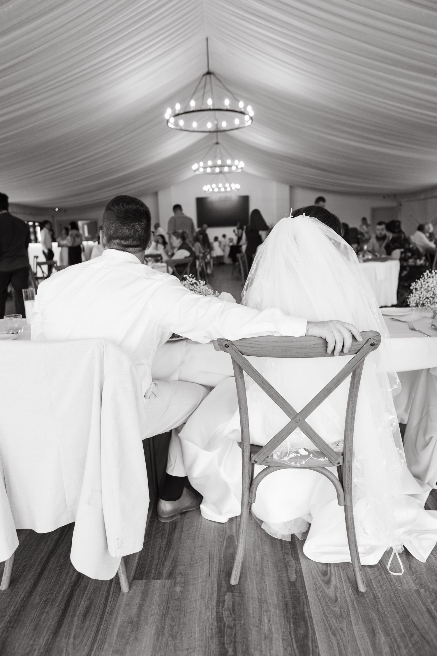 Bride and groom sitting at reception at Two Rivers Winery Wedding in Denman