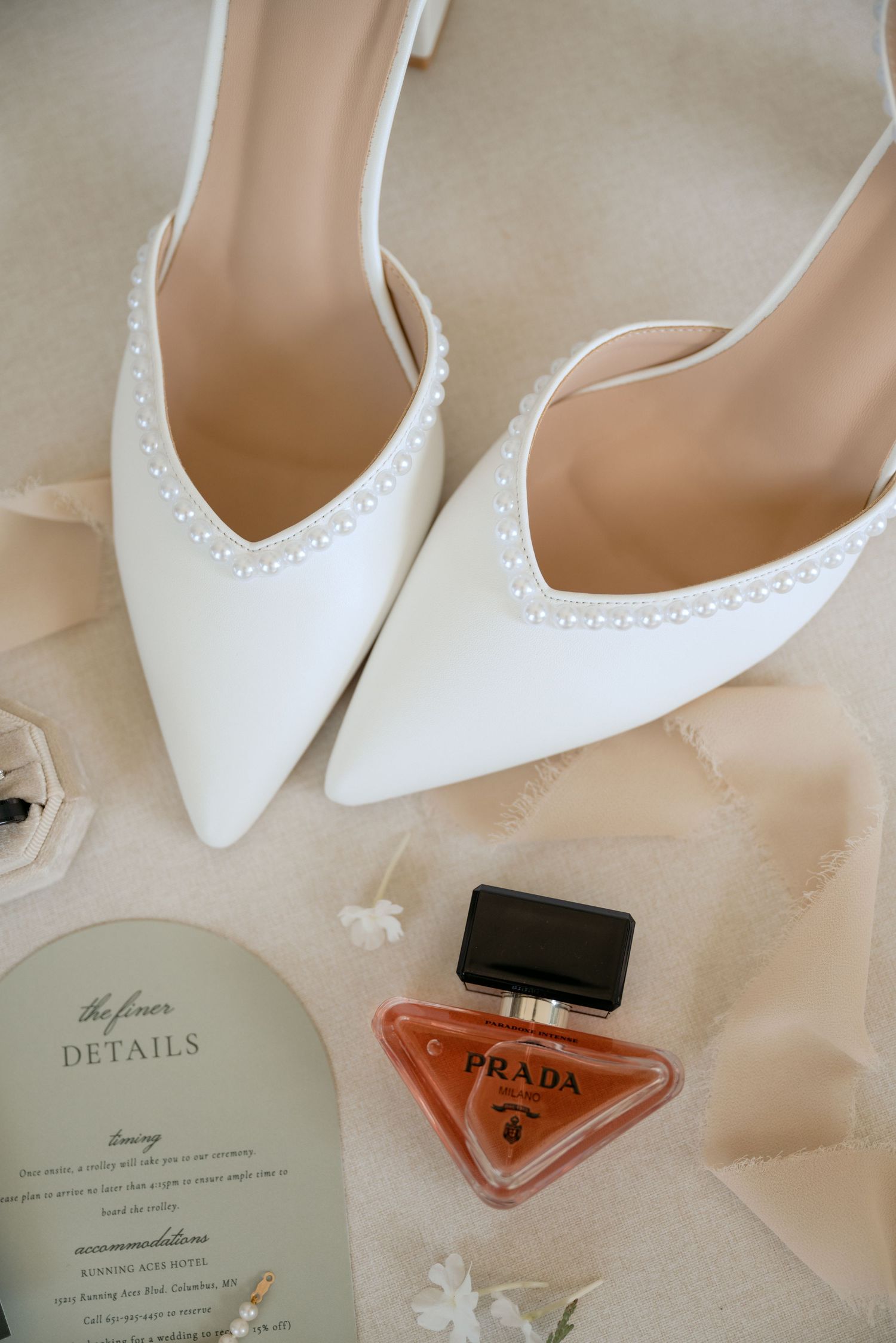 Wedding day details shown in a timeless and elegant manner, featuring pearled bridal shoes & Prada perfume, at Abella Weddings in Chisago MN