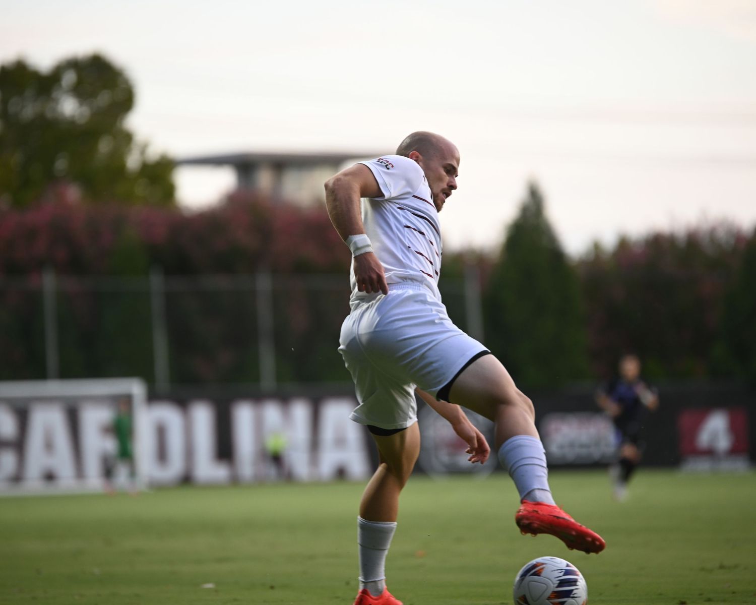 South Carolina soccer player controls the ball while running downfield.