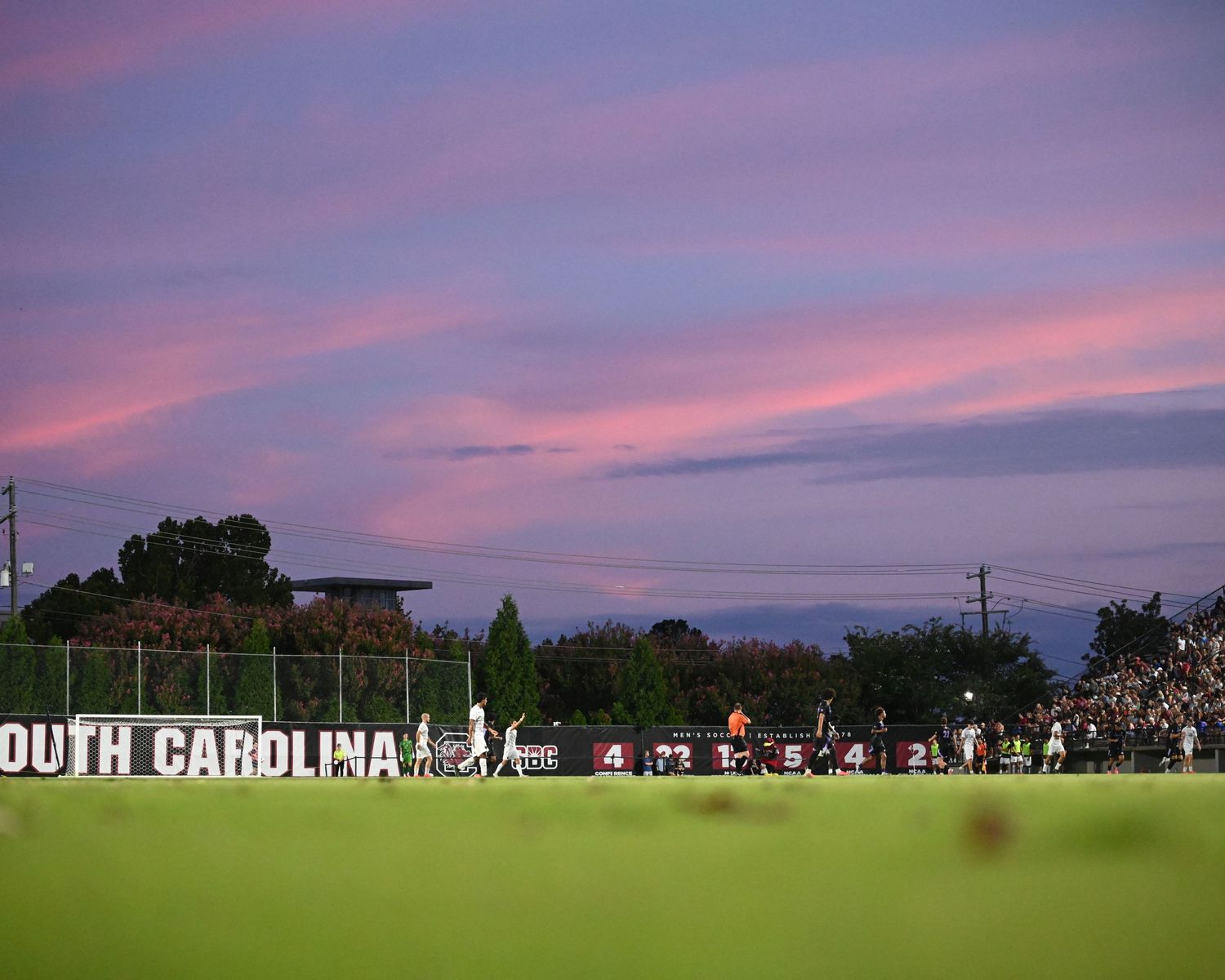South Carolina soccer field stretches beneath a pink and purple sunset.
