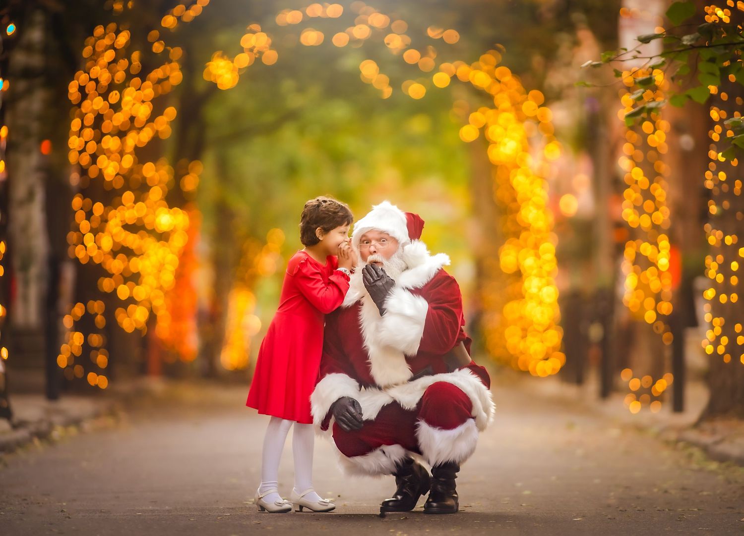 Young girl smiling with Santa during a magical holiday photography session in South Jersey.
