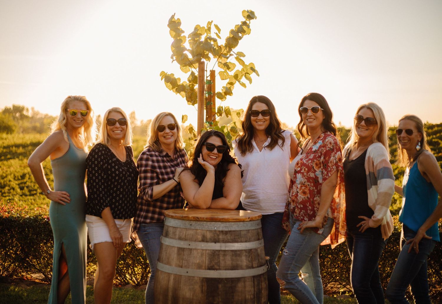 Large group of smiling women posing together at an indoor party or social gathering event.