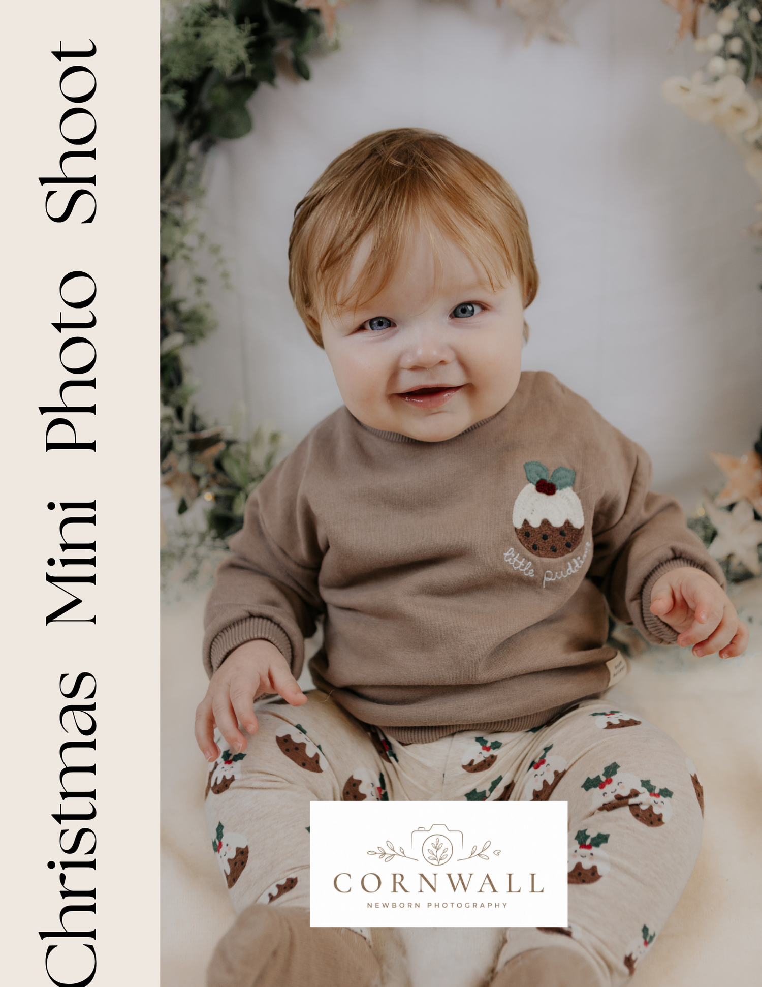 Smiling baby in festive Christmas pudding sweatshirt at Cornwall Newborn Photography mini shoot.
