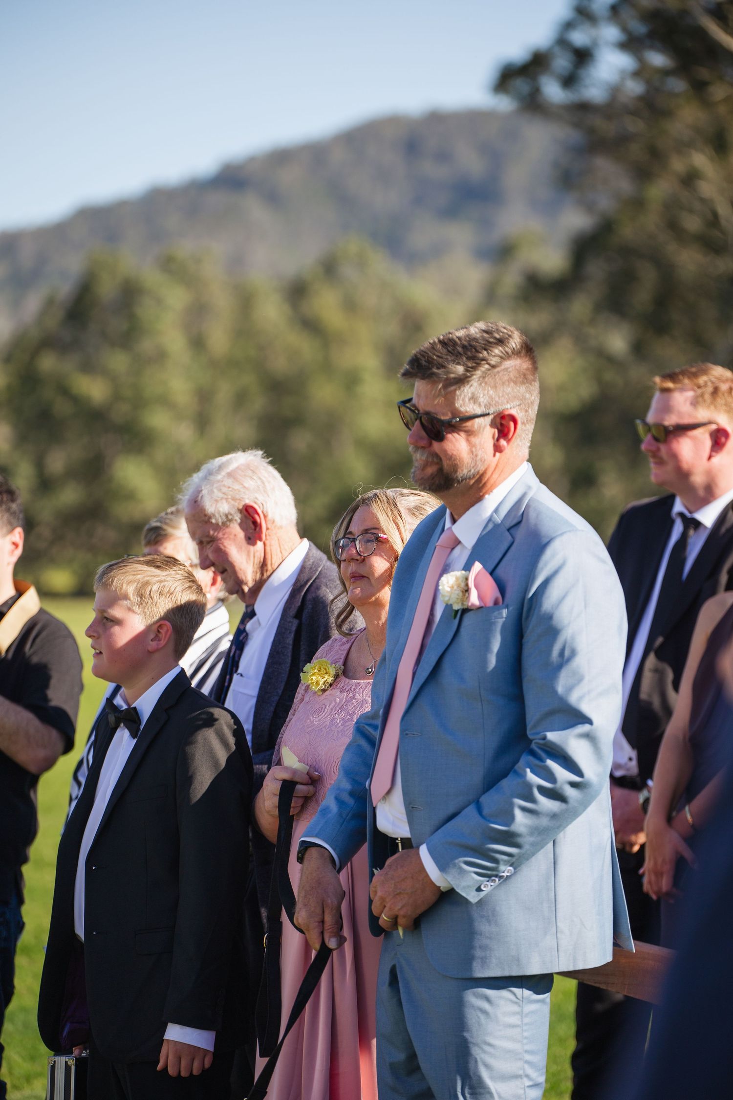 Father and mother of the groom at Jess and Lachie’s wedding ceremony overlooking the dam at Dungog Weddings