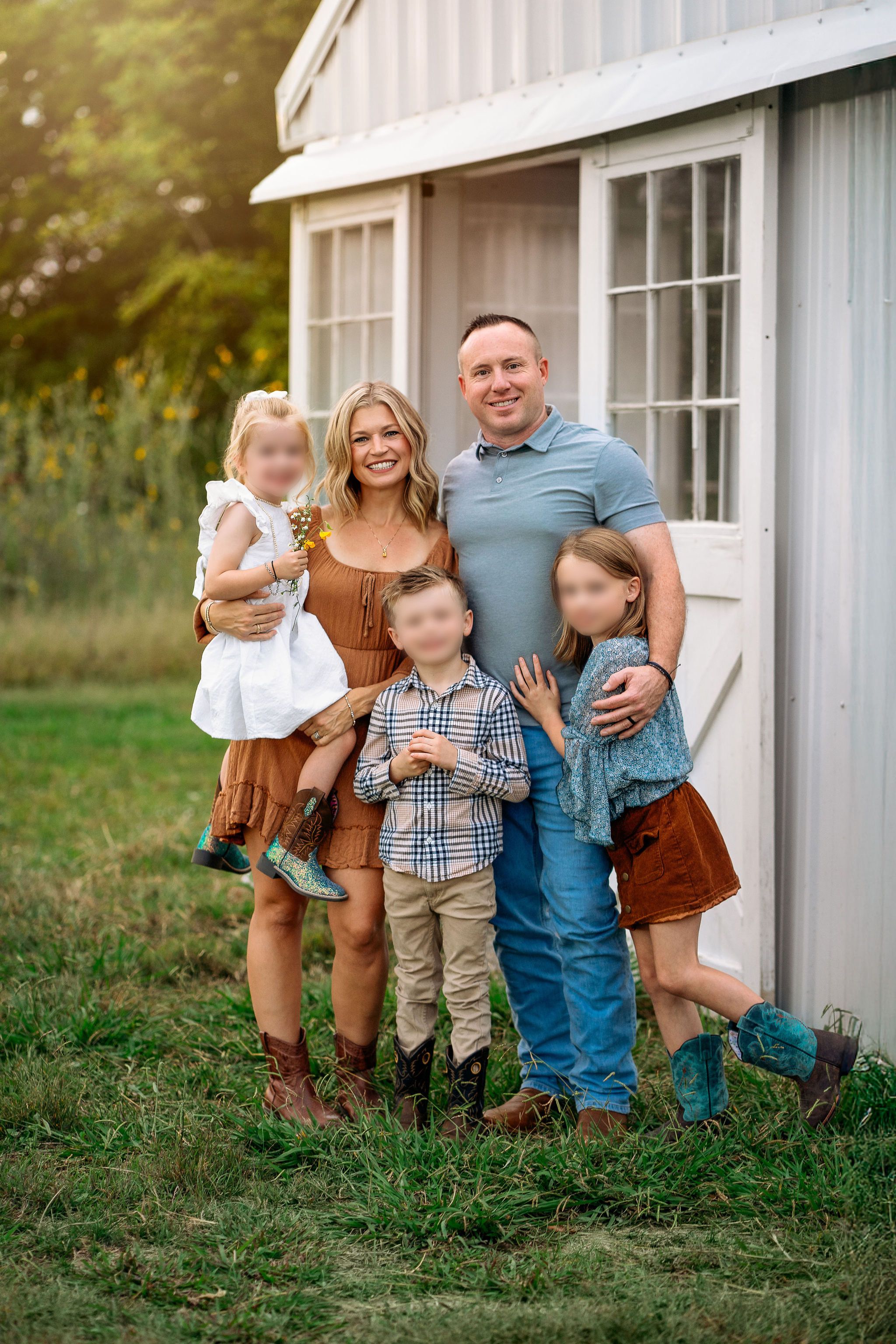 Family wearing coordinated rust, blue, cream, and tan outfits during a fall portrait session.