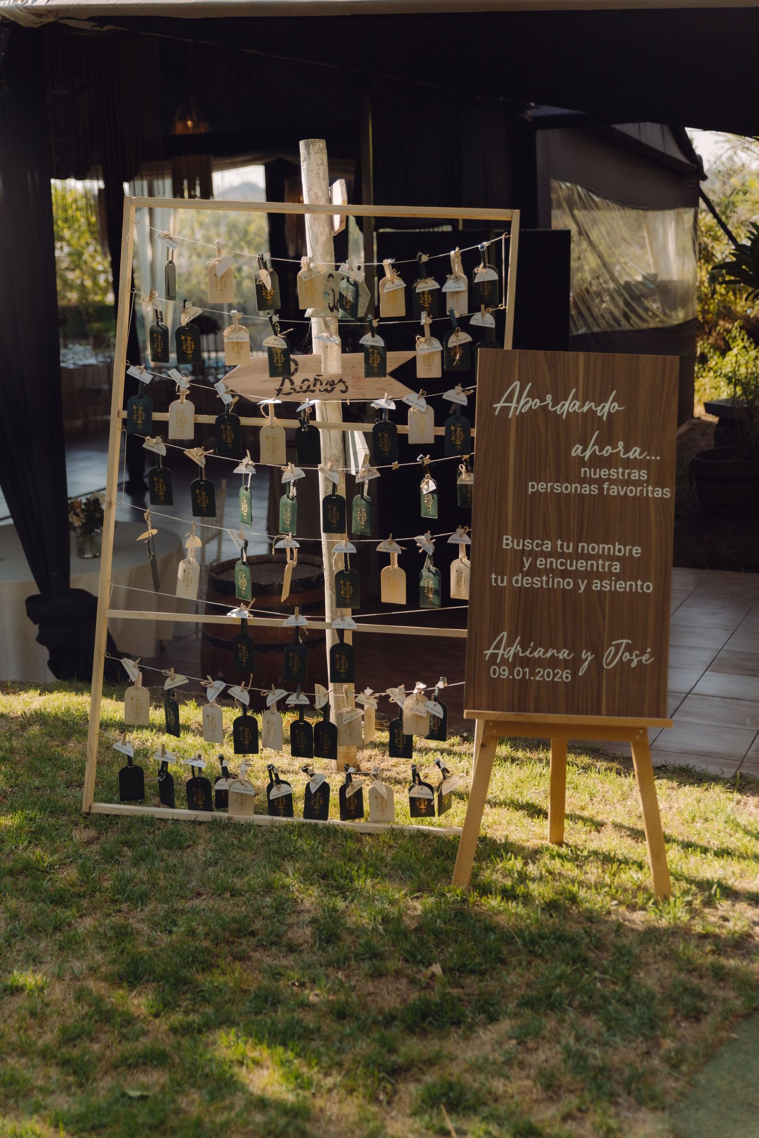 Wedding seating chart display on wooden easel with Spanish text for Adriana and Jose January 2026.
