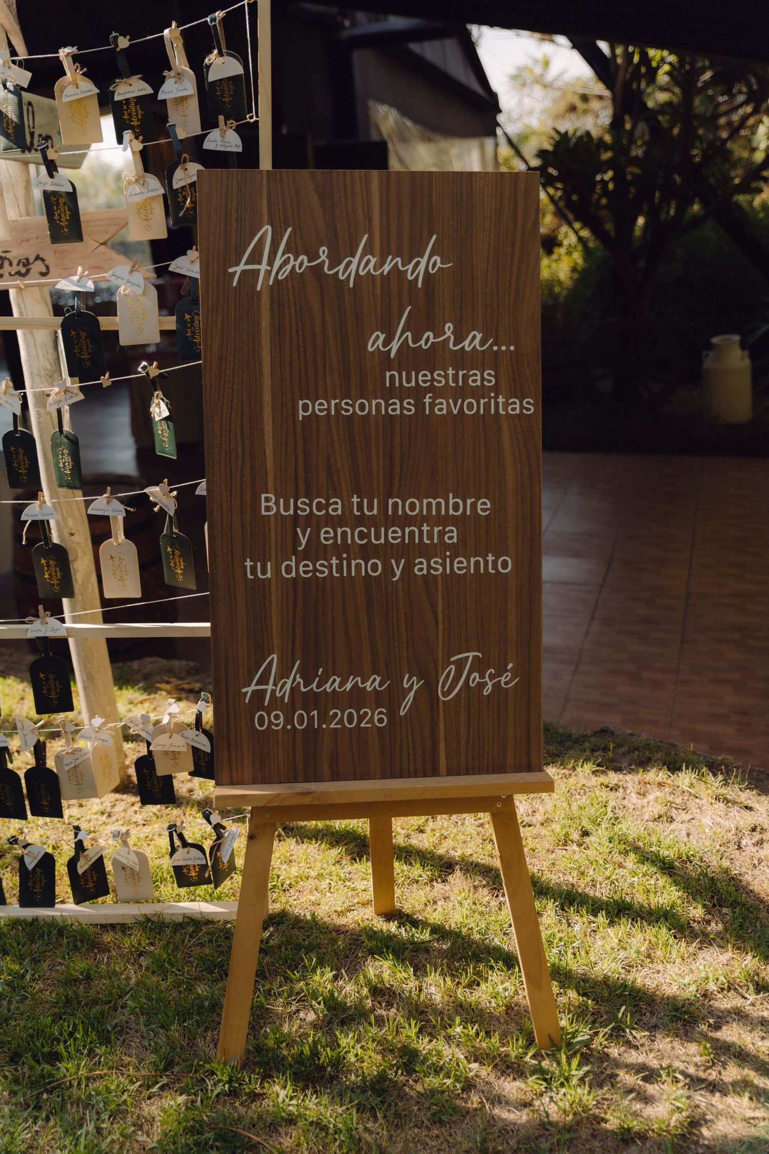 Elegant wooden wedding welcome sign in Spanish for Adriana and Jose dated January 9 2026.