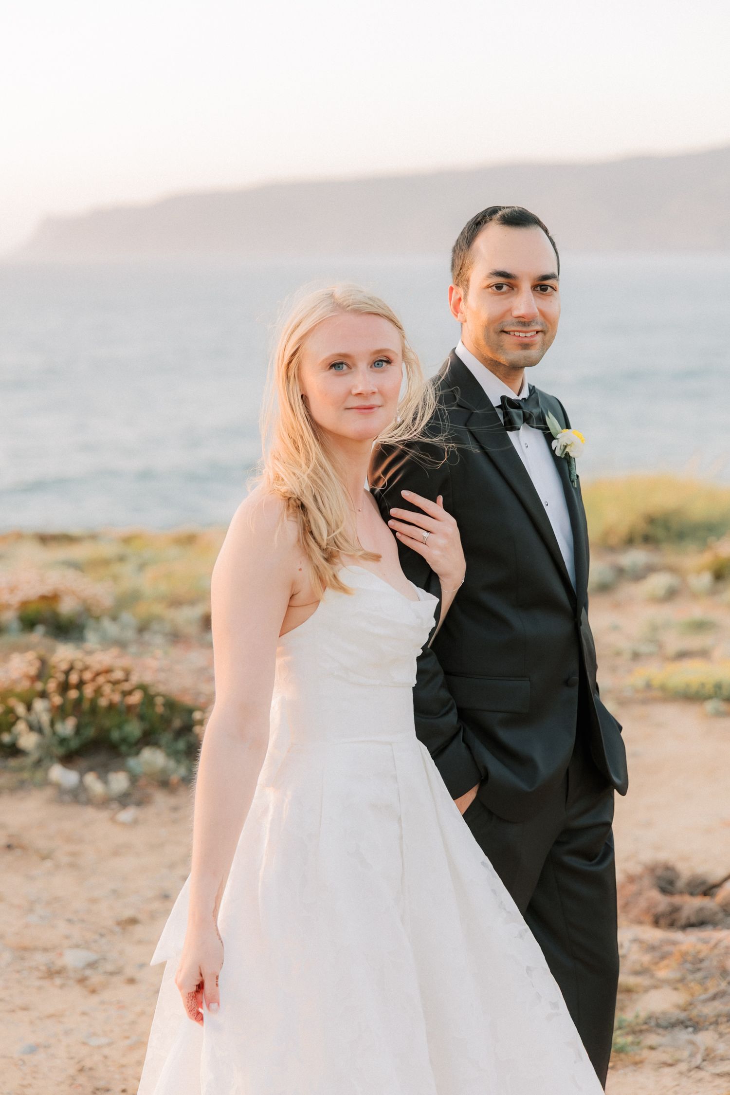 Romantic newlywed portrait captured during golden hour at Arriba by the Sea in Cascais.