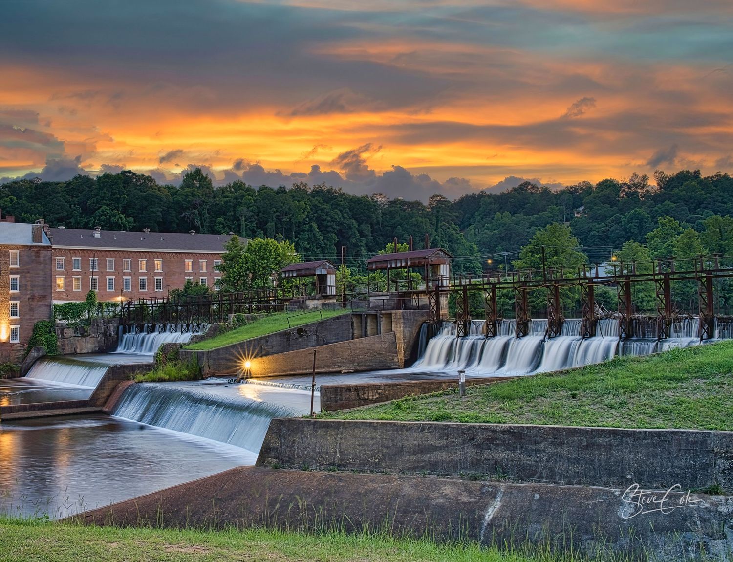 Historic Prattville Mill and dam spillway along Autauga Creek at dusk with colorful skies, fine art photo by Steve Cole Photography.