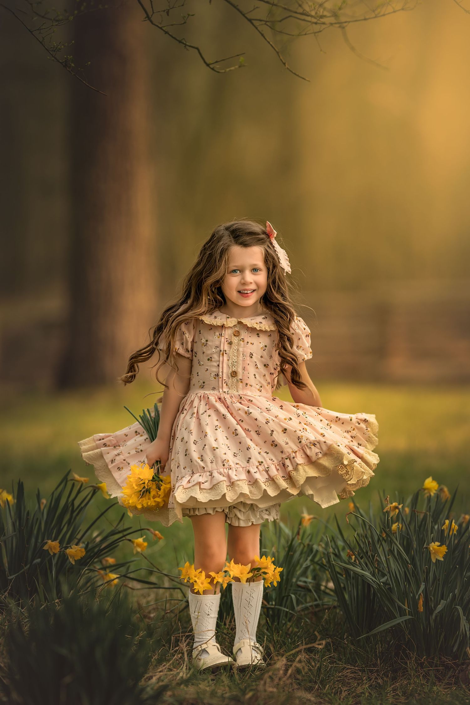 A smiling girl in a floral dress twirls among yellow daffodils in a sun-drenched garden.