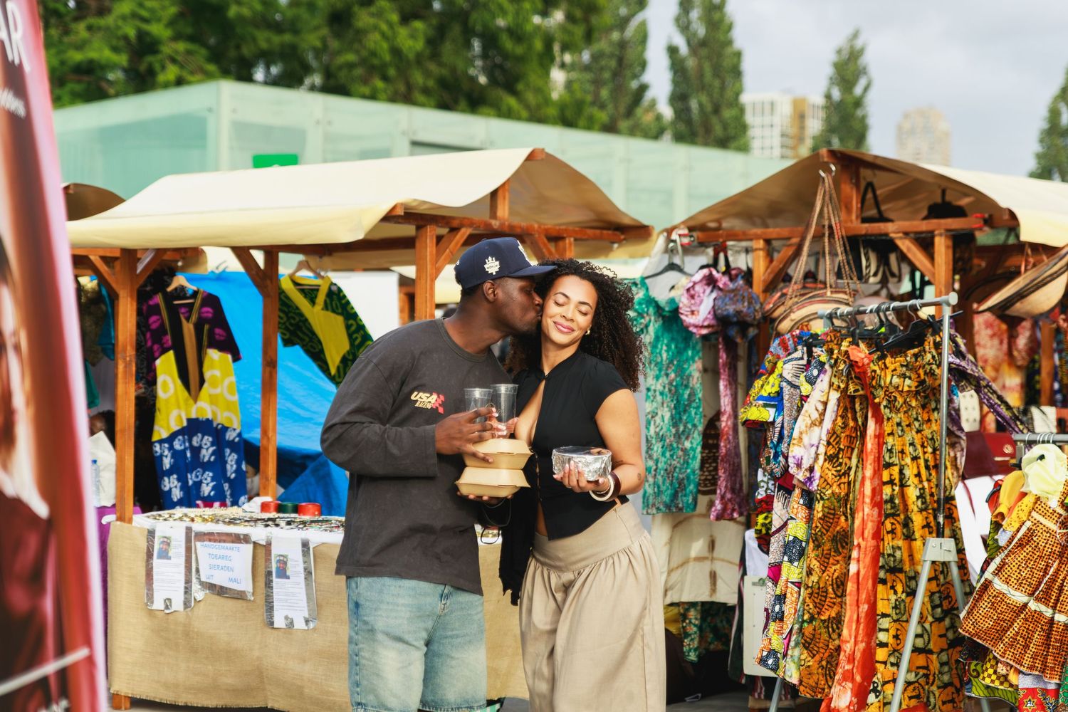 Couple share kiss and food during event coverage of African Food Festival 2026 by Netherlands photographer CKA Visuals.