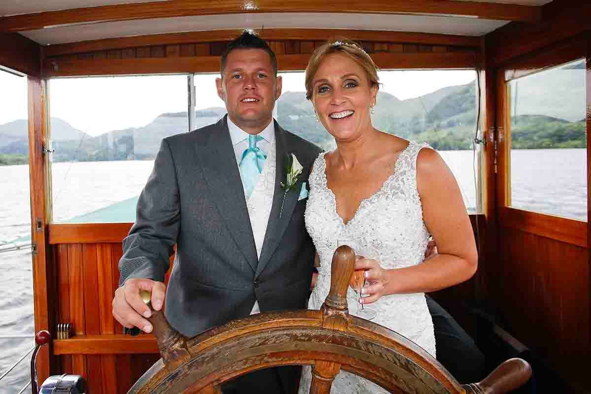 bride and groom get to drive the the steamer around lake derwentwater Keswick