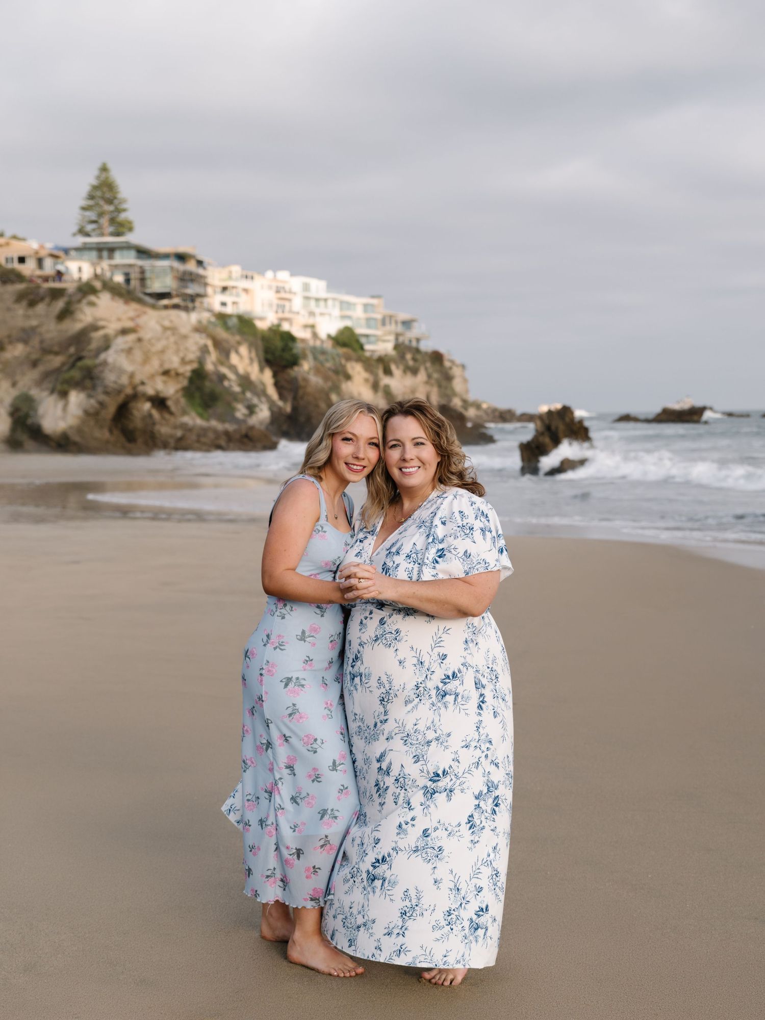 Mother and daughter standing together on the beach during a Newport Beach family photography session.