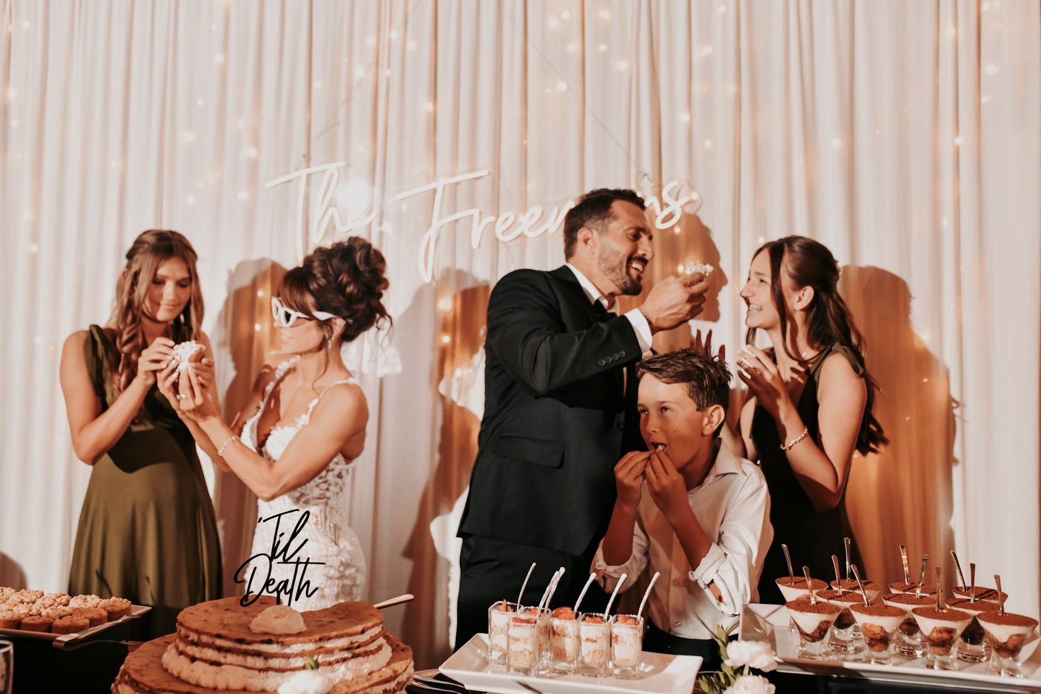 Megan and Joel celebrating with their children at the reception