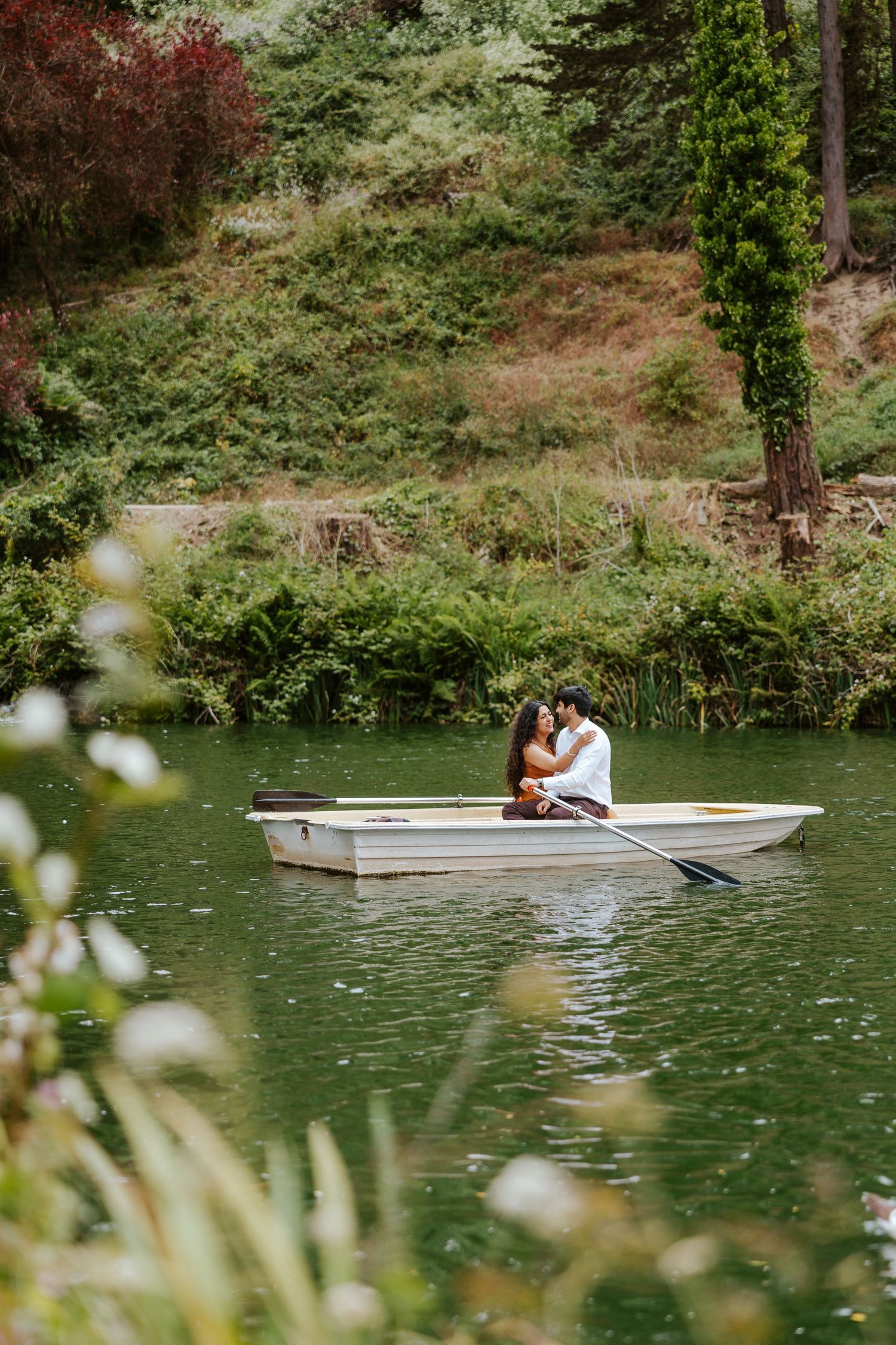 couple snuggling up in row boat in golden gate park, san francisco