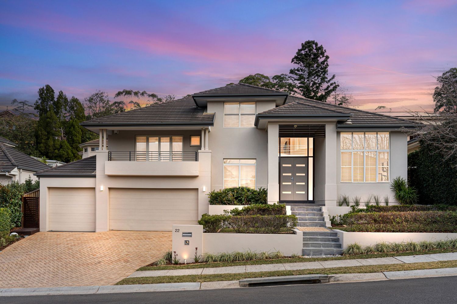 A twilight real estate photo of a two-story and double garage home in Castle Hill, NSW.