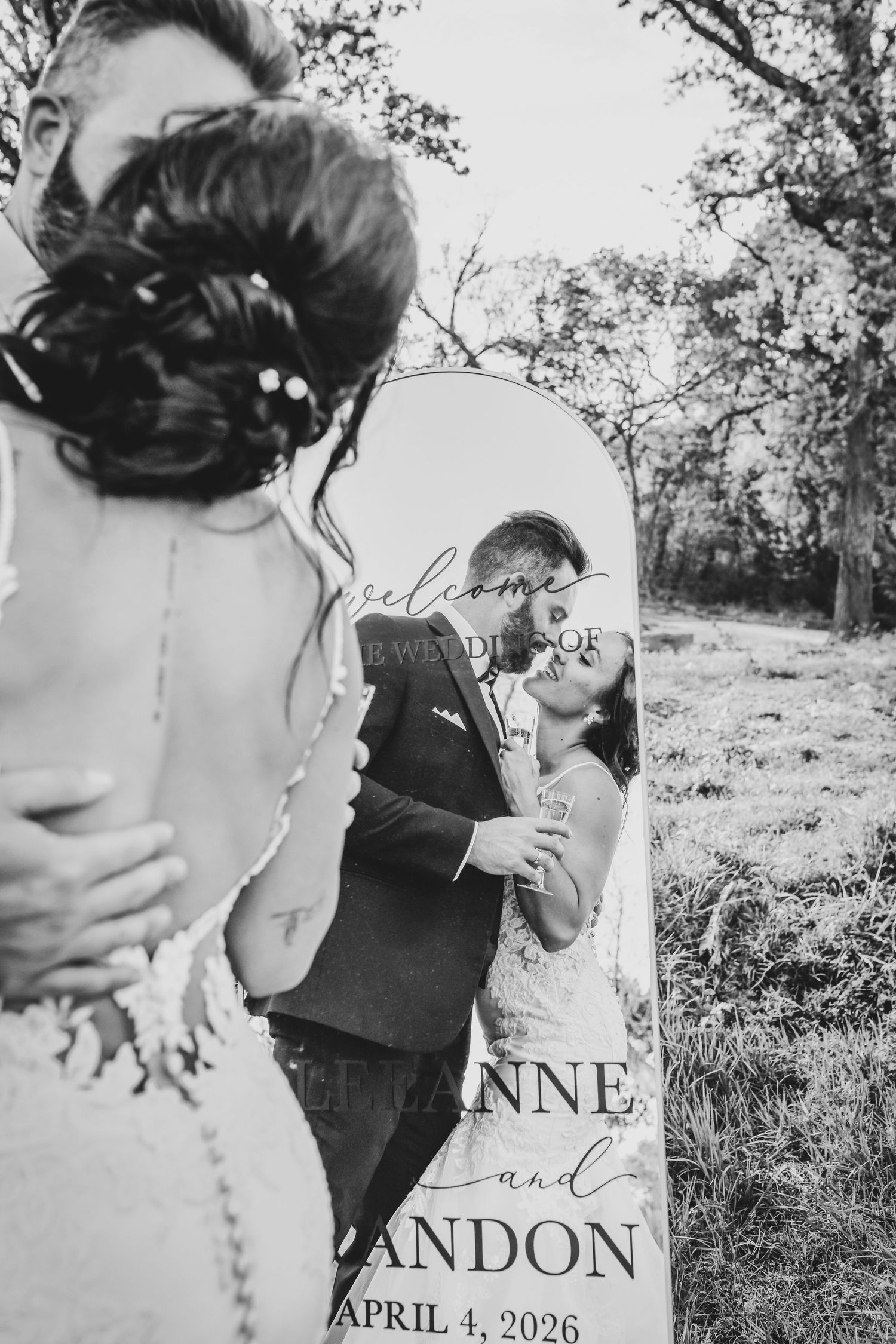 editorial image of bride and groom kissing in the mirror