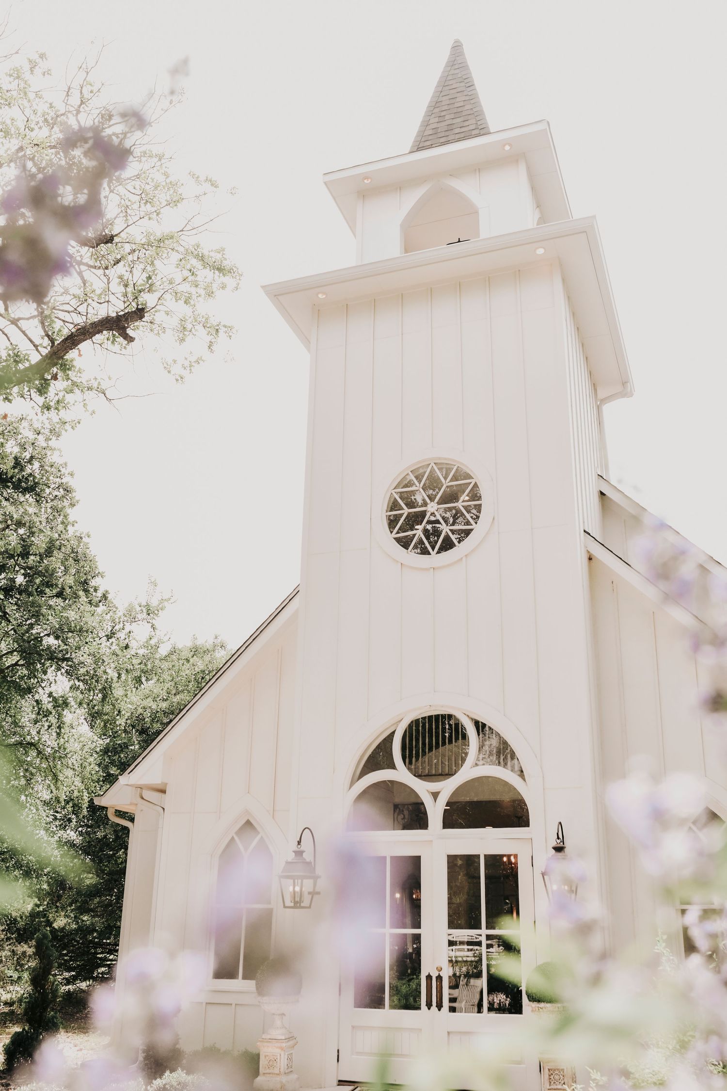Elegant white barn exterior at The French Farmhouse wedding venue in Collinsville TX