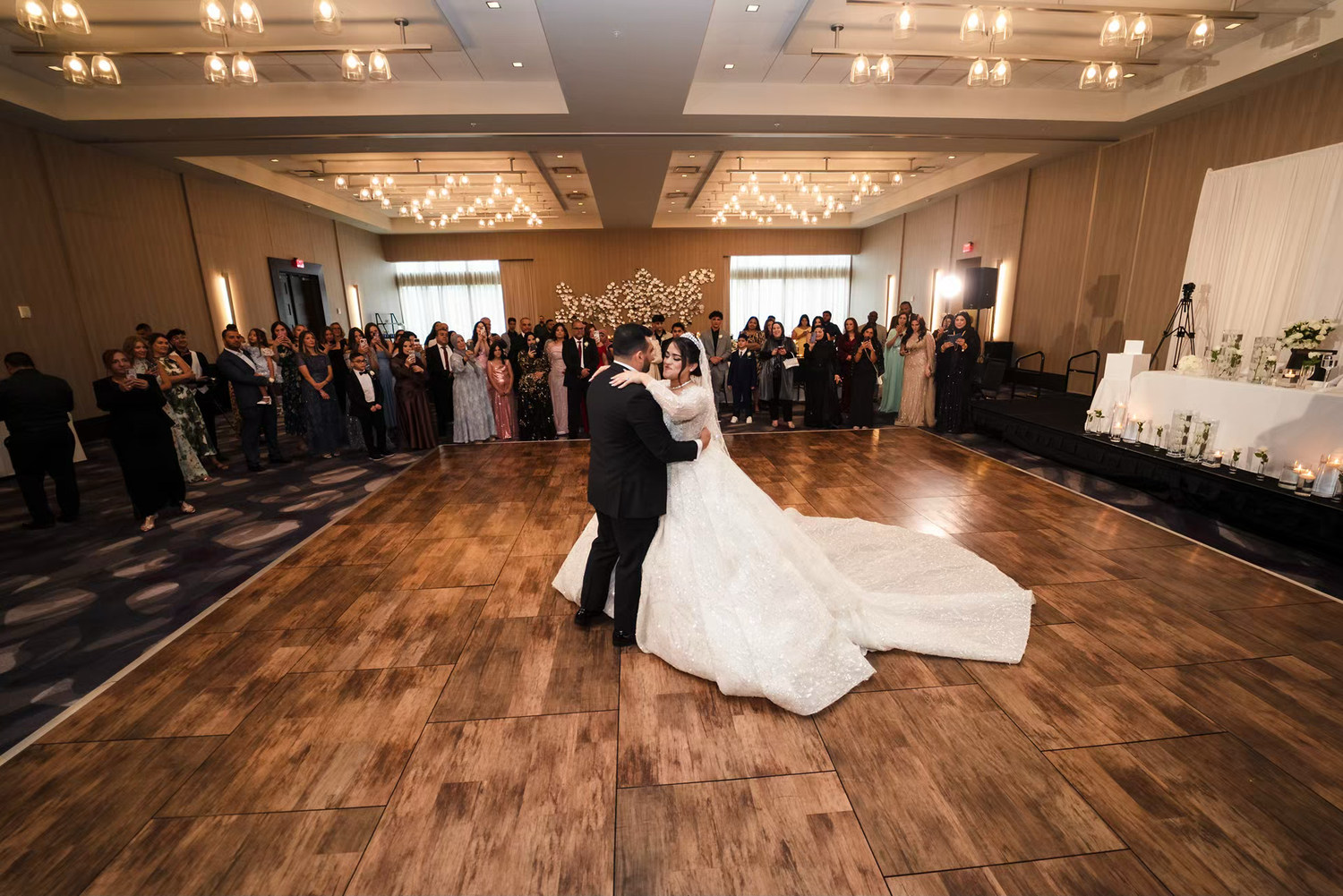 Bride and groom share first dance in elegant ballroom at renaissance  wedding venue.