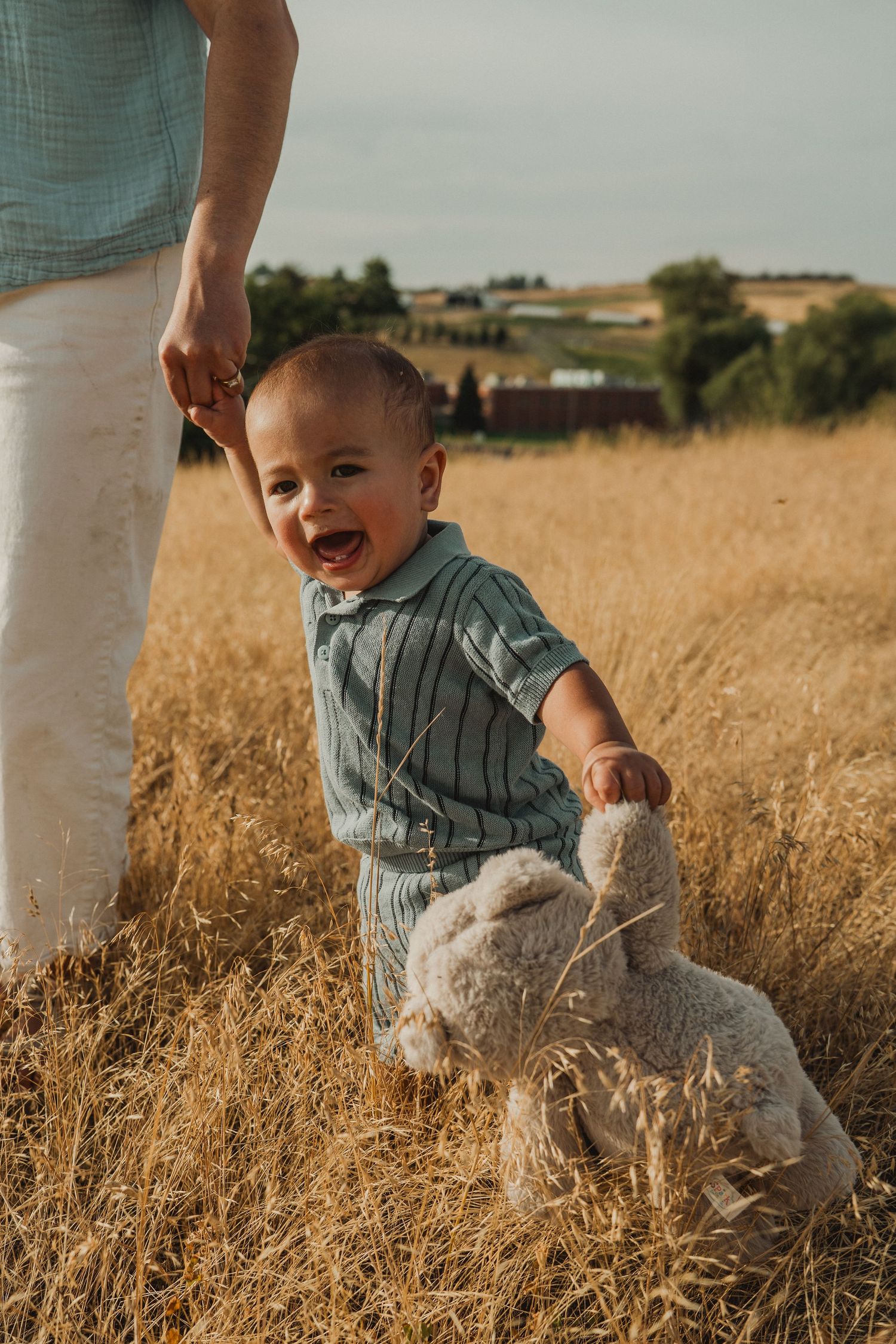 One-year-old baby enjoying an outdoor first birthday session in the field at the WSU Arboretum.