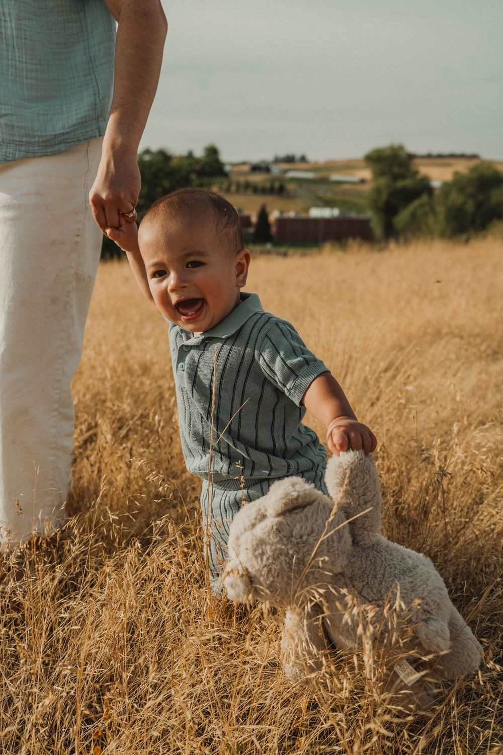 One-year-old baby enjoying an outdoor first birthday session in the field at the WSU Arboretum.