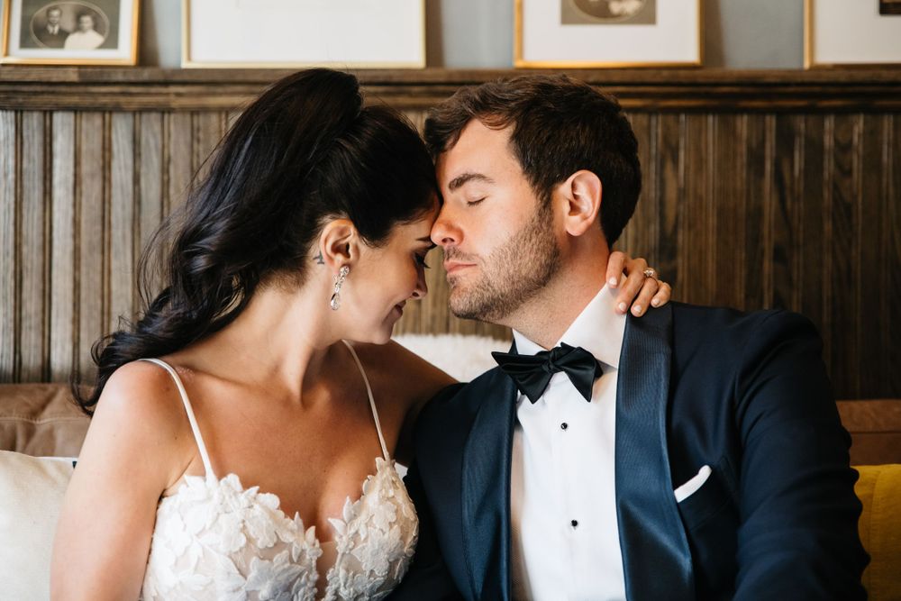 Intimate romantic moment captured between newlyweds in formal attire.