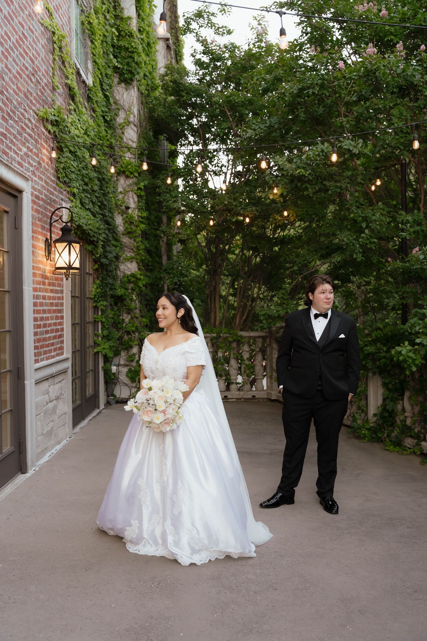 Couple walking hand in hand with dog during Dallas-Fort Worth wedding portrait