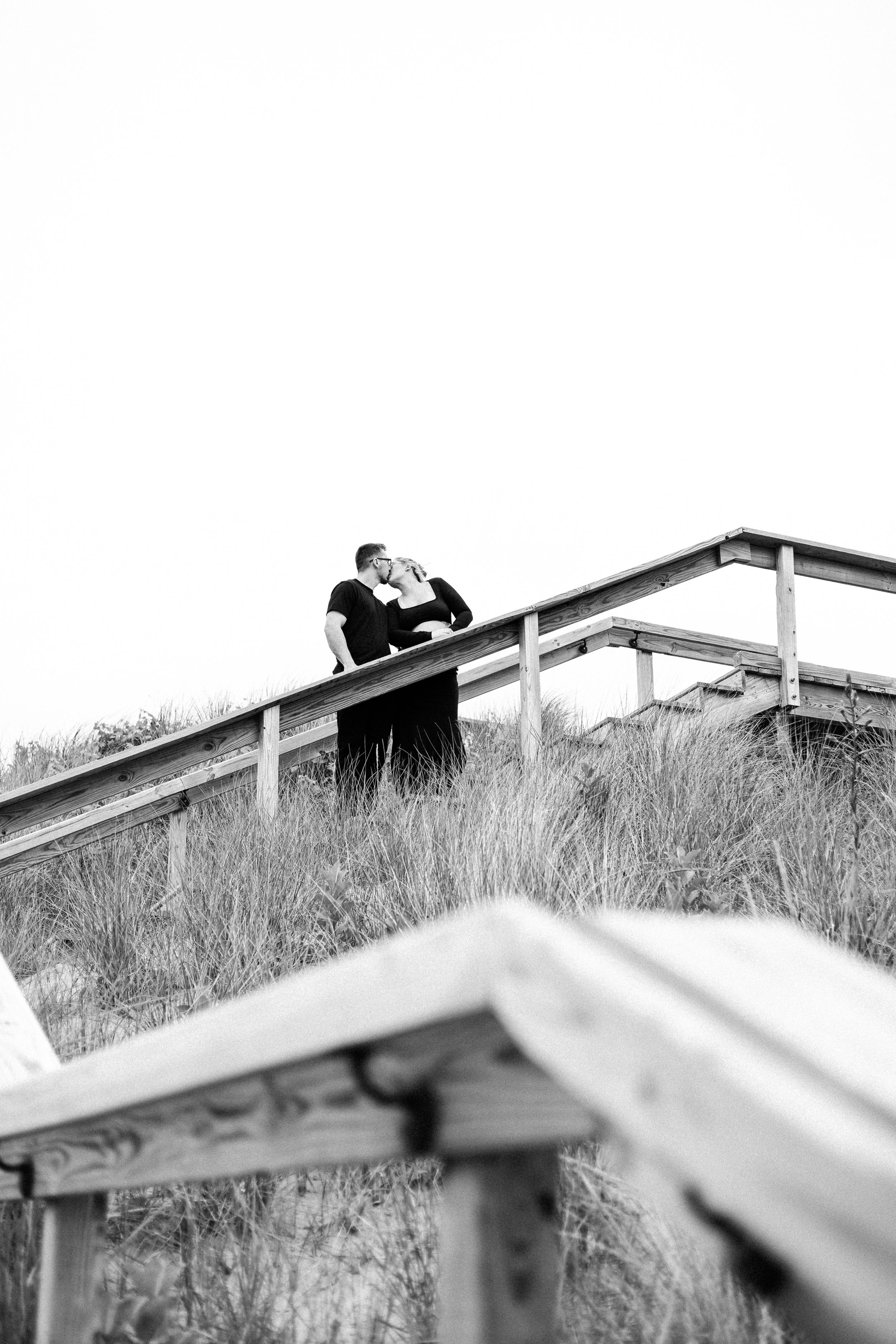 Black and white artistic series of silhouettes against tall grass landscape.