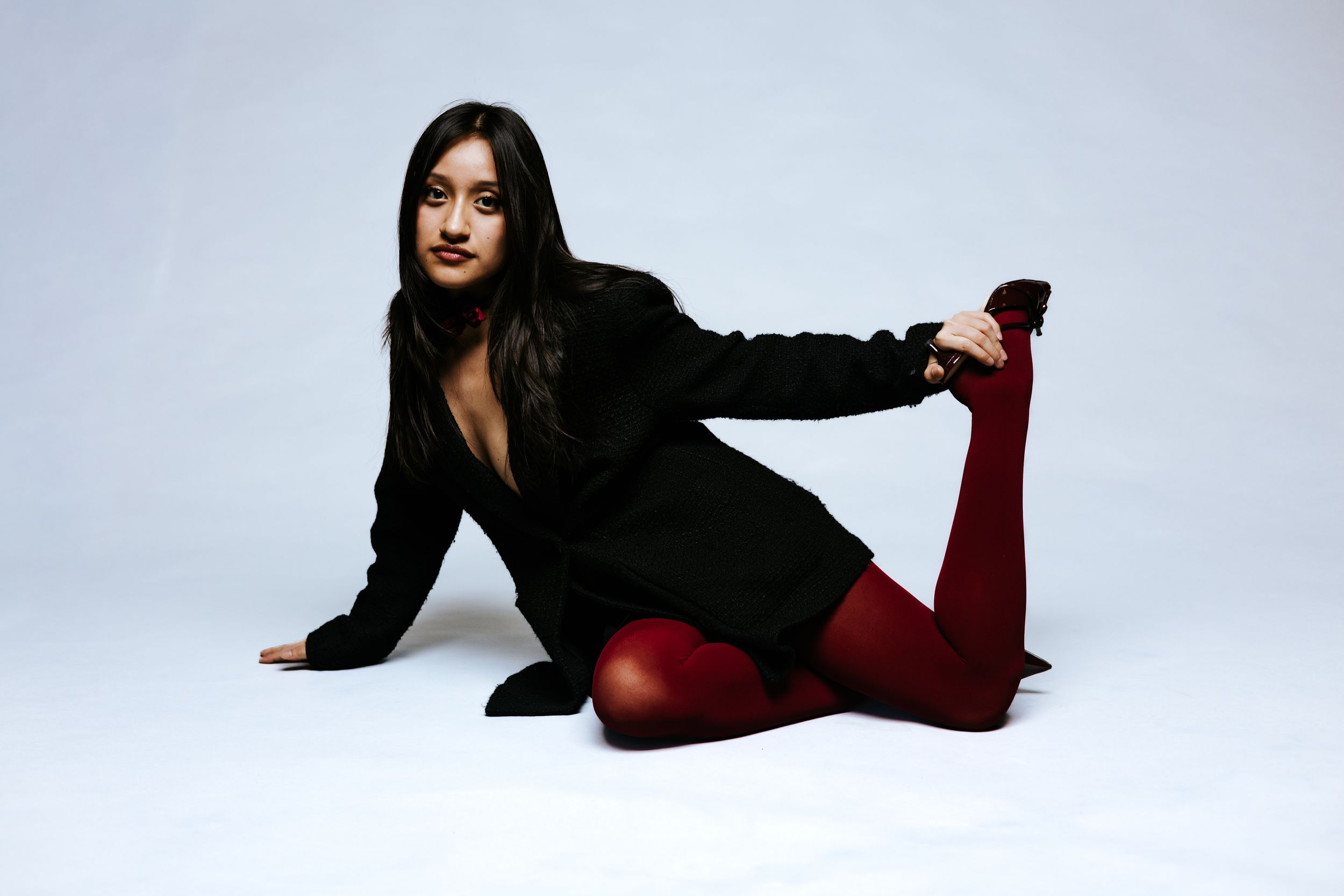Fashion portraits in black attire showing dynamic poses against white studio background.