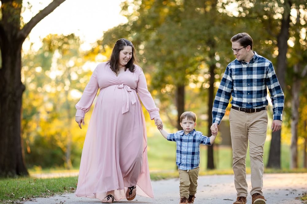 Expectant couple with their young son during a family maternity session in Mountain Home, Arkansas