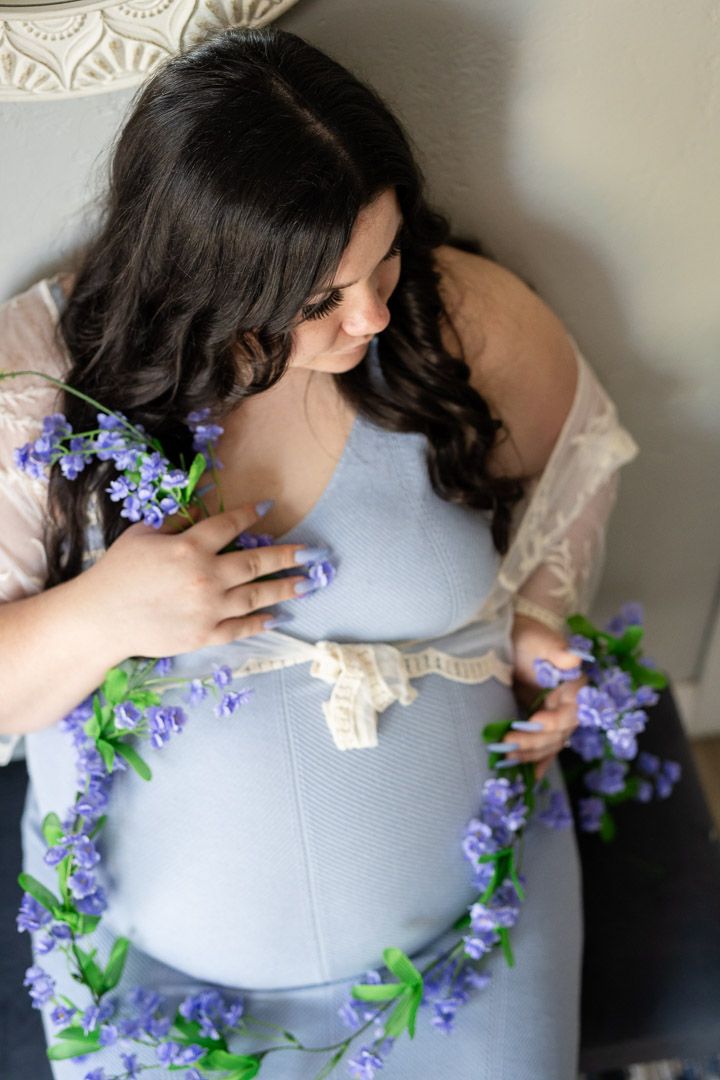 Expectant mother with flowers during a studio maternity session in Mountain Home, Arkansas