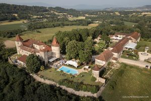 Panoramic aerial view of a countryside estate with rolling hills and forests.