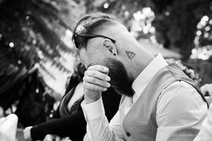 An intimate black and white moment captured during an outdoor celebration.
