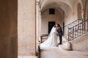 Elegant wedding photo shoot in a historic stone archway corridor.