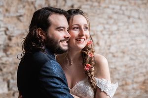 Romantic moment captured against a weathered brick wall background.