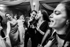 Black and white photos of wedding guests dancing and celebrating at a reception.