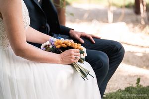 Romantic wedding couple shares intimate moments in a garden setting with soft natural lighting.