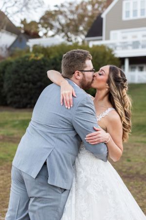 A tender embrace between a couple in wedding attire on their special day.