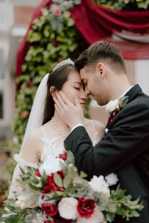 A romantic wedding moment captured in a series of intimate close-up shots with red and white floral decor.