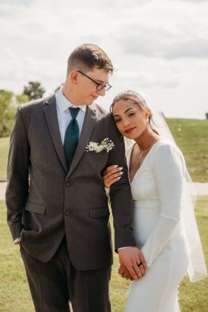 Intimate wedding portrait of couple on rolling green hills.