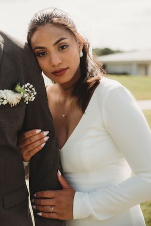 Close-up wedding portrait showing elegant bridal details.