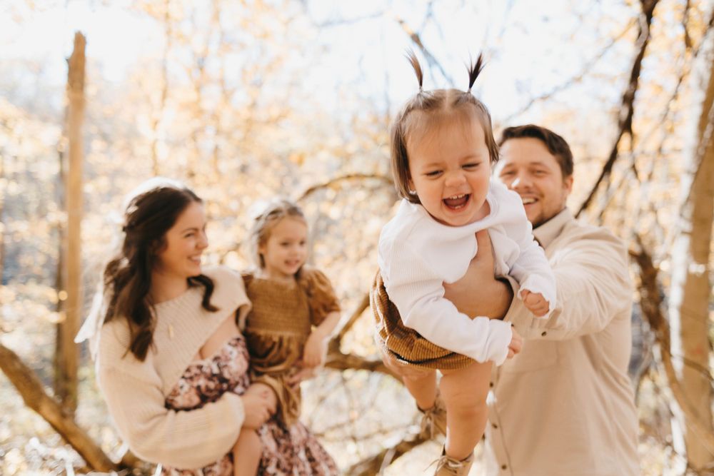 Family playing with their kids in outdoor fall photo