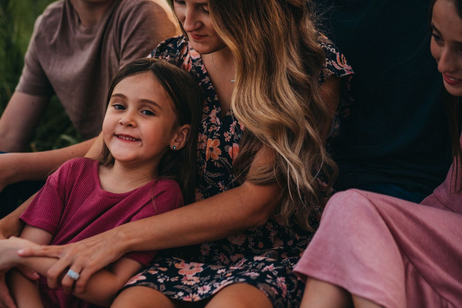 Family gathering moment captured outdoors with floral dress and casual attire.