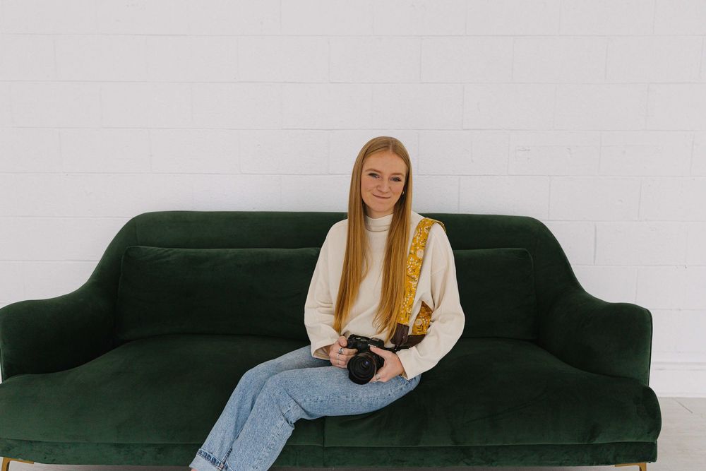Minimalist studio portraits on a green velvet couch against a white backdrop.