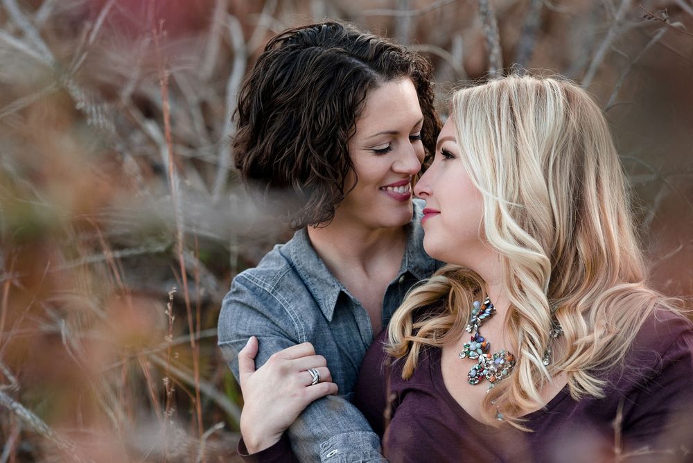 Intimate moment between couple during outdoor winter photoshoot.