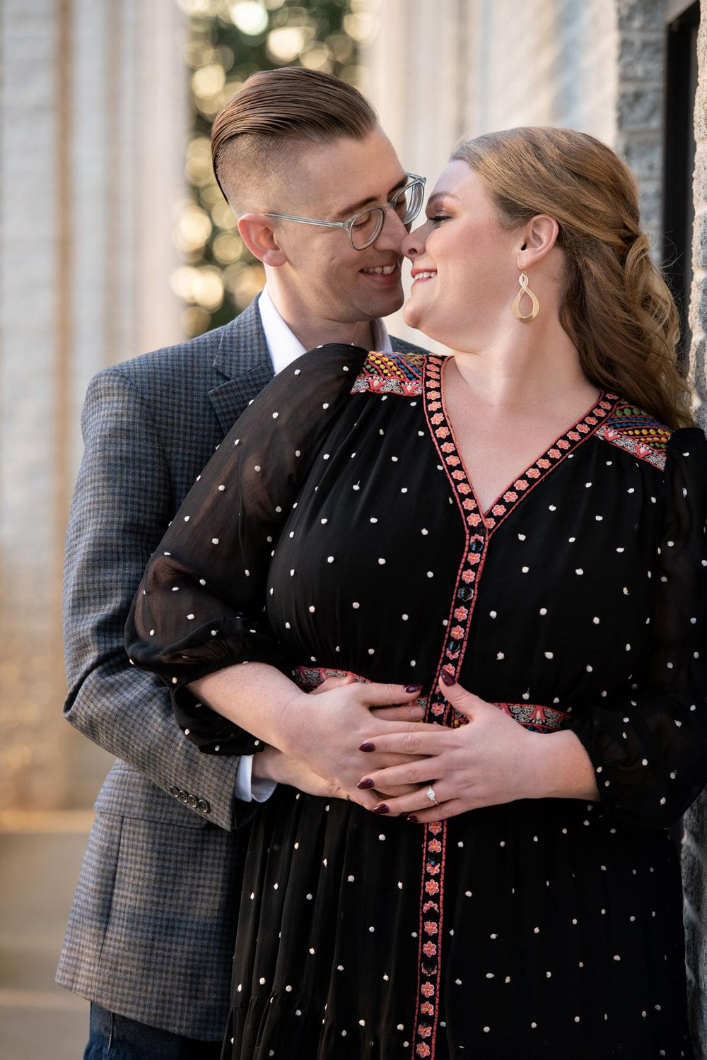 A couple sharing an intimate moment together during a romantic holiday photoshoot.