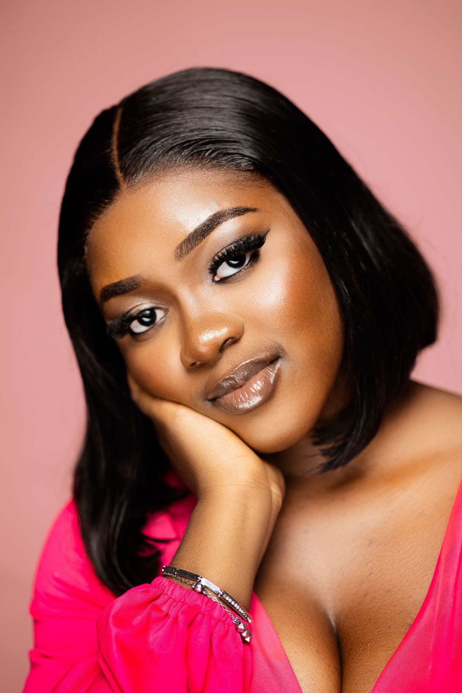Elegant beauty portrait with flawless makeup against pink backdrop.
