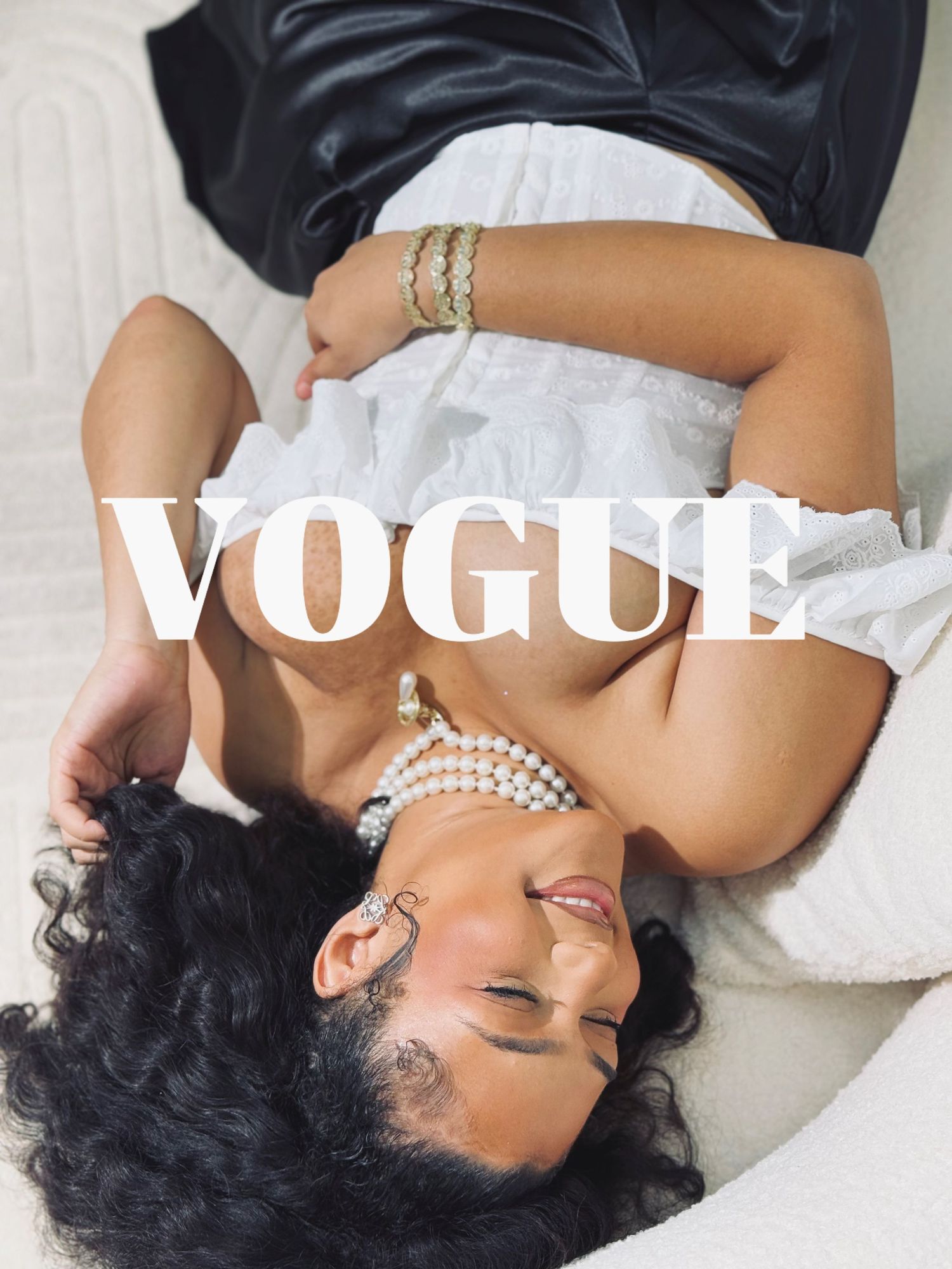 Artistic boudoir photography with Vogue text overlay in elegant white setting.